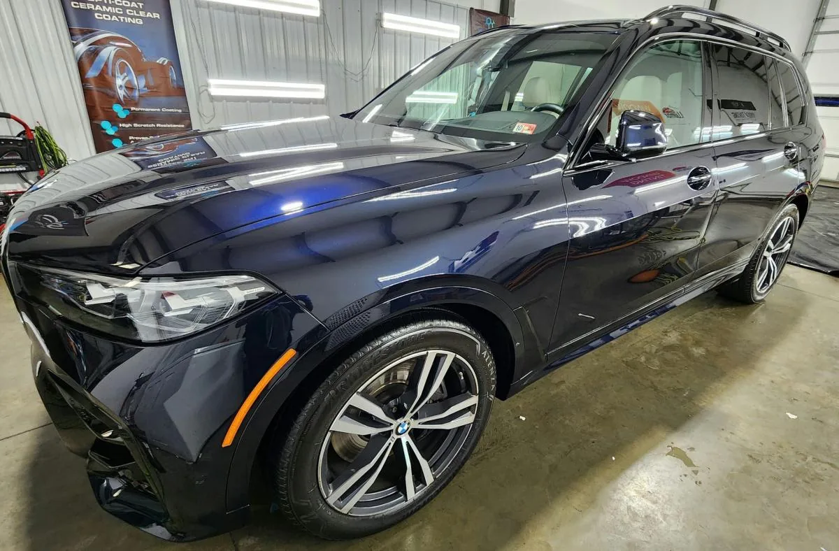 A black SUV with Opti-Coat ceramic coating applied by The Detail Guy